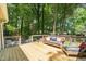 Cozy deck with outdoor seating surrounded by lush trees at 1317 Elmset Ln, Durham, NC 27713