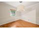 Cozy dining room featuring hardwood floors, a modern light fixture, and a window with backyard views at 1317 Elmset Ln, Durham, NC 27713
