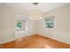 Open dining room with hardwood floors, stylish lighting, and seamless flow to adjoining living spaces at 1317 Elmset Ln, Durham, NC 27713