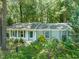 Charming single-story home with gray shutters and a wooded lot, creating a private and serene setting at 1317 Elmset Ln, Durham, NC 27713
