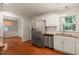 Open kitchen with stainless steel appliances and view into dining area, great for entertaining at 1317 Elmset Ln, Durham, NC 27713
