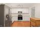 Well-lit kitchen with stainless steel appliances, white cabinets, and a functional butcher block island at 1317 Elmset Ln, Durham, NC 27713