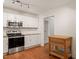 Updated kitchen with granite countertops, stainless steel appliances, and white cabinets, offering modern convenience at 1317 Elmset Ln, Durham, NC 27713