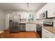 Bright kitchen with stainless steel appliances and white cabinets, perfect for cooking and entertaining at 1317 Elmset Ln, Durham, NC 27713