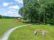 Community playground area with a walking path, benches, and play equipment at 1317 Elmset Ln, Durham, NC 27713