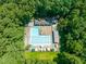 A beautiful pool and community area surrounded by mature trees and a grassy area at 1317 Elmset Ln, Durham, NC 27713
