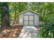 Wooden shed with a ramp in a wooded backyard at 1317 Elmset Ln, Durham, NC 27713