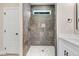 Contemporary bathroom showcasing a tiled shower, modern fixtures, and a white vanity at 157 Cherrybirch Ln, Zebulon, NC 27597