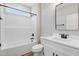 Bathroom featuring white cabinets, black hardware, and a shower-tub combination at 157 Cherrybirch Ln, Zebulon, NC 27597