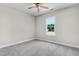 Bedroom with neutral walls, carpeted floors, ceiling fan, and a window offering natural light at 157 Cherrybirch Ln, Zebulon, NC 27597