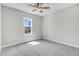 Bedroom with neutral walls, carpeted floors, ceiling fan, and a window offering natural light at 157 Cherrybirch Ln, Zebulon, NC 27597
