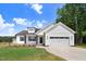 Beautifully designed two-story home featuring white siding, black accents, and a well-manicured lawn at 157 Cherrybirch Ln, Zebulon, NC 27597
