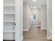 Bright hallway with wood flooring, built-in shelving, and modern finishes at 157 Cherrybirch Ln, Zebulon, NC 27597