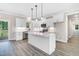 Modern kitchen with white cabinets, sleek countertops, stainless steel appliances, and hardwood floors at 157 Cherrybirch Ln, Zebulon, NC 27597