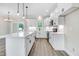 Modern kitchen with a large island, white cabinetry, and stainless steel appliances at 157 Cherrybirch Ln, Zebulon, NC 27597