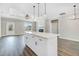 Open-concept kitchen with a large island, white cabinets, and modern pendant lighting at 157 Cherrybirch Ln, Zebulon, NC 27597