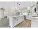 Spacious kitchen with a center island, white cabinets, and stainless steel appliances at 157 Cherrybirch Ln, Zebulon, NC 27597