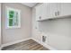 Laundry room featuring cabinets above connections and a window at 157 Cherrybirch Ln, Zebulon, NC 27597
