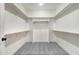 This walk-in closet has carpeted floors, shelving on all walls, and a center hanging rack at 157 Cherrybirch Ln, Zebulon, NC 27597