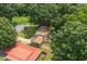 Aerial view of the backyard, including mature trees, a detached garage, and a covered back porch at 1704 Little John Ct, Burlington, NC 27217