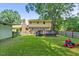 Angled backyard view showcasing the deck and playset at 1704 Little John Ct, Burlington, NC 27217