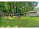 Backyard view showcasing the play set with swings, slide, and playhouse for the  at 1704 Little John Ct, Burlington, NC 27217
