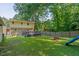 Angled backyard view showcasing the deck and playset at 1704 Little John Ct, Burlington, NC 27217
