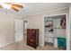 Bedroom with a ceiling fan, closet with shelving and view to hall and stairs at 1704 Little John Ct, Burlington, NC 27217