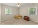 Versatile bedroom space with two windows offering natural light and neutral-colored walls at 1704 Little John Ct, Burlington, NC 27217