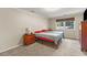 Cozy bedroom with natural light from the window and neutral decor; perfect for relaxation at 1704 Little John Ct, Burlington, NC 27217