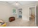 Bright bedroom with neutral walls, closet and view to the hall and stairs at 1704 Little John Ct, Burlington, NC 27217
