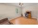 Spacious bedroom with hardwood floors, ceiling fan, and a desk with computer at 1704 Little John Ct, Burlington, NC 27217