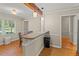 Eat-in dining area with hardwood floors, granite countertop breakfast bar, and modern pendant lighting at 1704 Little John Ct, Burlington, NC 27217