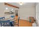 Open dining area with wood-look flooring, exposed beam, and view into the kitchen at 1704 Little John Ct, Burlington, NC 27217