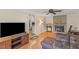 Inviting living room with hardwood floors, ceiling fan, and brick fireplace at 1704 Little John Ct, Burlington, NC 27217