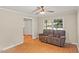 Comfortable living room with hardwood floors, ceiling fan, and plush recliner sofa at 1704 Little John Ct, Burlington, NC 27217