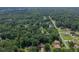 Aerial view of the lush, green neighborhood of single Gathering homes surrounded by mature trees at 1704 Little John Ct, Burlington, NC 27217