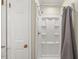 Bathroom featuring an enclosed shower with a gray curtain, and a white door on the left at 1704 Little John Ct, Burlington, NC 27217