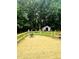 Inviting backyard deck with a fire pit and view of storage shed surrounded by lush landscaping and mature trees at 175 Ann Dr, Timberlake, NC 27583