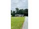 Picturesque home with a sprawling front yard, gravel driveway, and mature trees at 175 Ann Dr, Timberlake, NC 27583