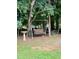 Backyard featuring a wooden swing, mature trees, and bird bath at 175 Ann Dr, Timberlake, NC 27583