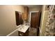 Well-lit bathroom featuring wooden cabinets and a shower at 181 Mangums Dr, Wendell, NC 27591