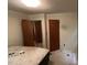 This bedroom features white walls, linoleum flooring, and two closet doors at 181 Mangums Dr, Wendell, NC 27591