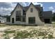 Stunning new construction home boasting a stone facade and black framed windows at 200 Meadow Walk Dr, Fuquay Varina, NC 27526