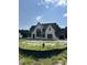 View of newly constructed home, featuring stone accents and a spacious three-car garage at 200 Meadow Walk Dr, Fuquay Varina, NC 27526