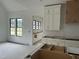 Bright, spacious kitchen featuring white cabinets, gold hardware, and a decorative wood vent hood at 200 Meadow Walk Dr, Fuquay Varina, NC 27526