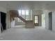 Spacious living room under construction with raw staircase and ample natural light at 200 Meadow Walk Dr, Fuquay Varina, NC 27526