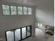 Bright living room showcasing soaring ceilings and a wall of windows with backyard views at 200 Meadow Walk Dr, Fuquay Varina, NC 27526