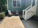 Back patio with chairs for seating and steps leading up to the backyard at 2012 Ranch Mill Cir, Raleigh, NC 27610