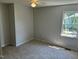 A bedroom with neutral carpeting and a window at 2012 Ranch Mill Cir, Raleigh, NC 27610